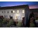 Exterior view of a townhome with a deck and landscaped backyard at dusk at 3185 Quinn Pl, Atlanta, GA 30341