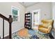 Hallway nook featuring a bookshelf, colorful rug, and yellow accent chair at 3185 Quinn Pl, Atlanta, GA 30341