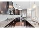 Gourmet kitchen features granite countertops, stainless steel appliances, and dark cabinetry at 3185 Quinn Pl, Atlanta, GA 30341