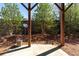 Concrete patio area under a roof, surrounded by trees and shrubs at 3185 Quinn Pl, Atlanta, GA 30341