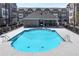 A community swimming pool with a covered seating area, surrounded by a wrought iron fence at 3185 Quinn Pl, Atlanta, GA 30341