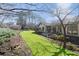 A lush green lawn leads to a seating area, gardens, and a charming home exterior at 541 Buckingham Cir, Marietta, GA 30066