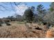 View of a beautiful backyard with a fire pit and seating near raised garden beds at 541 Buckingham Cir, Marietta, GA 30066