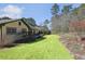 Spacious backyard featuring manicured lawn, established landscaping, and a view of the home's exterior at 541 Buckingham Cir, Marietta, GA 30066