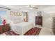 Bedroom featuring a bright window, red rug, light walls, and a ceiling fan at 541 Buckingham Cir, Marietta, GA 30066