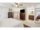 View of primary bedroom featuring ensuite bathroom, ceiling fan, and decorative accents at 541 Buckingham Cir, Marietta, GA 30066