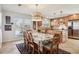 Dining area with a large window, wooden chairs, and an adjacent kitchen with modern appliances at 541 Buckingham Cir, Marietta, GA 30066