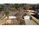 Aerial view of a single-story home with a two-car garage and manicured landscaping surrounded by mature trees at 541 Buckingham Cir, Marietta, GA 30066