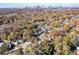 Stunning aerial view of wooded property and neighborhood near the city skyline at 944 Woodland Se Ave, Atlanta, GA 30316