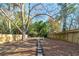 Large backyard features a wooden fence and a stone walkway at 944 Woodland Se Ave, Atlanta, GA 30316