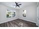 This bedroom has hardwood floors, a ceiling fan and two windows at 944 Woodland Se Ave, Atlanta, GA 30316