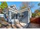 Image showcasing the exterior of a gray painted home featuring a covered front porch with brick pillars at 944 Woodland Se Ave, Atlanta, GA 30316