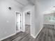 Hallway showcasing gray flooring and fresh paint, leading to various rooms at 944 Woodland Se Ave, Atlanta, GA 30316