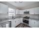 Bright kitchen featuring stainless steel appliances and white cabinets at 944 Woodland Se Ave, Atlanta, GA 30316