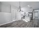 Open-concept view of a well-lit living area and kitchen with gray walls and hardwood floors at 944 Woodland Se Ave, Atlanta, GA 30316