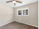 This bedroom has neutral walls, a ceiling fan and a window at 1088 Lloyd Dr, Forest Park, GA 30297