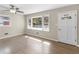 Inviting living room featuring light wood floors, large windows, and a ceiling fan at 1088 Lloyd Dr, Forest Park, GA 30297