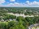 Picturesque aerial view featuring a serene lake surrounded by lush greenery and well-spaced homes in a peaceful neighborhood at 1430 Watercove Ln, Lawrenceville, GA 30043