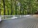 Large, private back deck surrounded by mature trees, offering a serene outdoor space at 1430 Watercove Ln, Lawrenceville, GA 30043