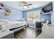 Bright blue bedroom with a twin bed, desk, chair, and a large window at 1430 Watercove Ln, Lawrenceville, GA 30043