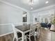 Elegant dining room with hardwood floors, modern lighting, and access to living spaces at 1430 Watercove Ln, Lawrenceville, GA 30043