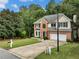 Two-story brick home with a well-manicured lawn, green shutters, and a two-car garage at 1430 Watercove Ln, Lawrenceville, GA 30043