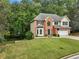 Two-story brick home with a well-manicured lawn, green shutters, and a two-car garage at 1430 Watercove Ln, Lawrenceville, GA 30043