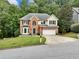 Two-story brick home with a well-manicured lawn, green shutters, and a two-car garage at 1430 Watercove Ln, Lawrenceville, GA 30043