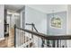Upstairs hallway with hardwood floors and an arched window at the top of the stairs at 1430 Watercove Ln, Lawrenceville, GA 30043
