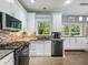 Updated kitchen with granite countertops, stainless steel appliances, gas range, and mosaic backsplash at 1430 Watercove Ln, Lawrenceville, GA 30043