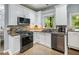 Modern kitchen boasts stainless steel appliances, granite counters, and backsplash at 1430 Watercove Ln, Lawrenceville, GA 30043