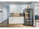 Modern kitchen featuring white cabinets, granite countertops, stainless steel appliances, and hardwood flooring at 1430 Watercove Ln, Lawrenceville, GA 30043