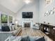 Cozy living room with high ceilings, fireplace, large windows, plush sofa, and modern decor at 1430 Watercove Ln, Lawrenceville, GA 30043