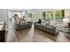 Spacious living area connecting to the kitchen featuring hardwood floors, large windows, and comfortable seating at 1430 Watercove Ln, Lawrenceville, GA 30043
