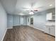 Open-concept living room with luxury vinyl plank flooring, light gray walls and a ceiling fan at 1430 Watercove Ln, Lawrenceville, GA 30043