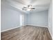 Living room featuring luxury vinyl plank flooring, light gray walls, and a white door at 1430 Watercove Ln, Lawrenceville, GA 30043