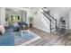 Bright living room with wood flooring, neutral paint, flows into dining and foyer at 1430 Watercove Ln, Lawrenceville, GA 30043