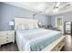Comfortable main bedroom with a white paneled bedframe, matching nightstands and gray wood-look floors at 1430 Watercove Ln, Lawrenceville, GA 30043