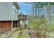 The backyard view shows an elevated deck with brick foundation, and natural landscaping at 1830 Jan Hill Ne Ln, Atlanta, GA 30329