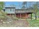 Backyard view shows an elevated deck with brick foundation, and natural landscaping at 1830 Jan Hill Ne Ln, Atlanta, GA 30329