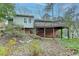 Backyard view shows an elevated deck with brick foundation, and natural landscaping at 1830 Jan Hill Ne Ln, Atlanta, GA 30329
