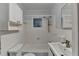 Clean bathroom featuring a tiled tub, sink and mirror with neutral paint and updated fixtures at 1830 Jan Hill Ne Ln, Atlanta, GA 30329