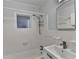 Bathroom featuring a white bathtub, toilet, and sink with white tiles throughout the room at 1830 Jan Hill Ne Ln, Atlanta, GA 30329