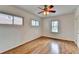 A well-lit, empty bedroom featuring light colored walls, a ceiling fan, and wood flooring at 1830 Jan Hill Ne Ln, Atlanta, GA 30329
