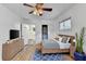 A modern bedroom with an attached bathroom, a large bed, a blue rug, and ample storage space at 1830 Jan Hill Ne Ln, Atlanta, GA 30329