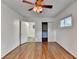A well-lit bedroom with wood flooring, ceiling fan, closet, and connecting bathroom at 1830 Jan Hill Ne Ln, Atlanta, GA 30329