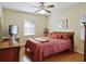 Cozy bedroom boasts a comfortable bed, rich hardwood floors, and a bright ceiling fan at 1830 Jan Hill Ne Ln, Atlanta, GA 30329
