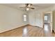 A bright bedroom featuring wood flooring, a ceiling fan, and a hall with an entry door at 1830 Jan Hill Ne Ln, Atlanta, GA 30329