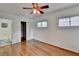 Bedroom featuring hardwood floors, ceiling fan, a closet and multiple windows at 1830 Jan Hill Ne Ln, Atlanta, GA 30329