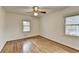 A simple, bright bedroom with hardwood floors and two windows for ample natural light at 1830 Jan Hill Ne Ln, Atlanta, GA 30329